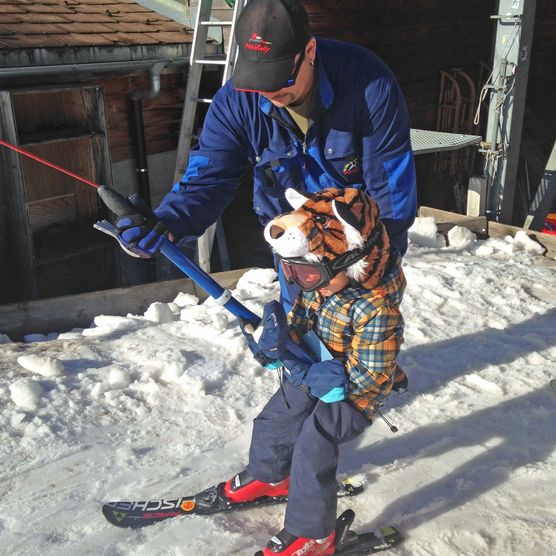 Picture Alexander Erb helps the child to get on the lift - to the picture