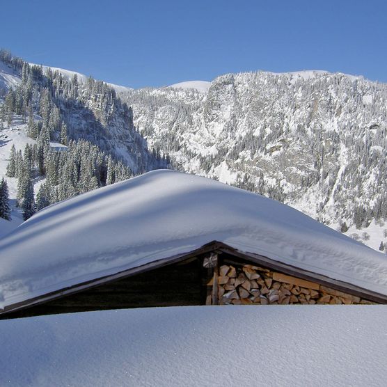 Picture deeply snow covered alpine hut - to the picture