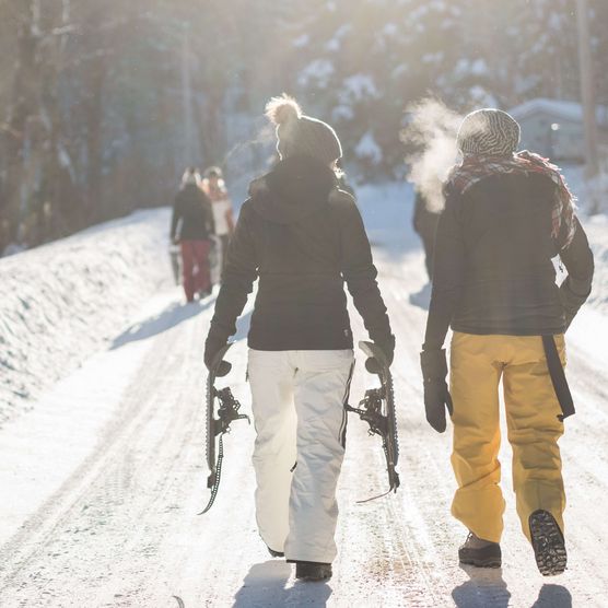 Picture two people are walking along the snowcovered path - to the picture